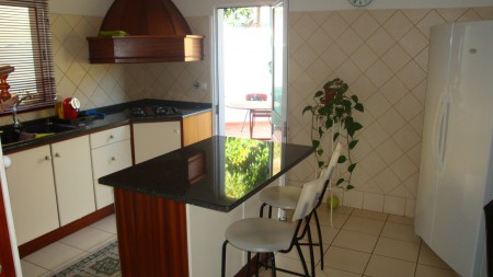 Looking from the hallway through the kitched onto the patio and BBQ area